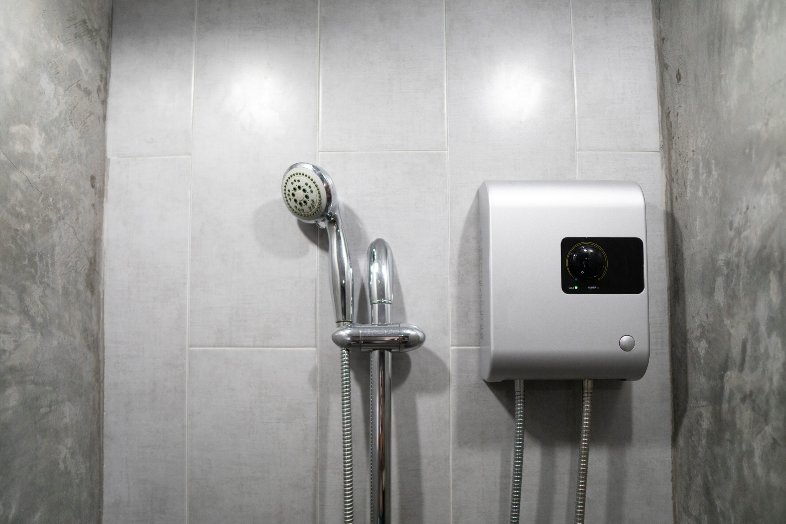Instant,Tankless,Electric,Water,Heater,Installed,On,Grey,Tile,Wall