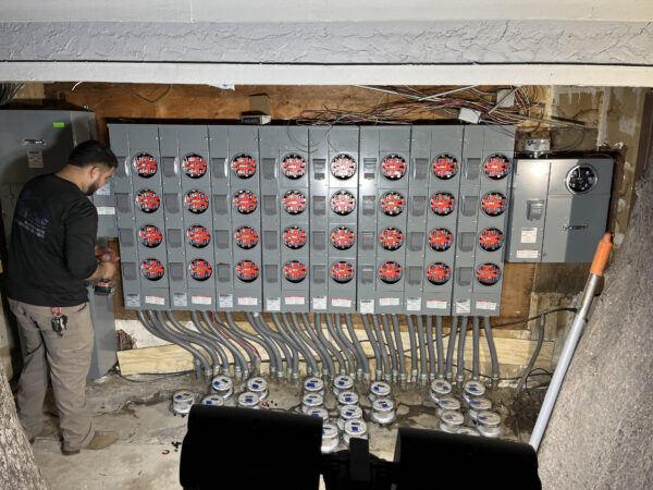 PC Home Services electrician installing a new meter stack for a multi-unit apartment building electrical upgrade