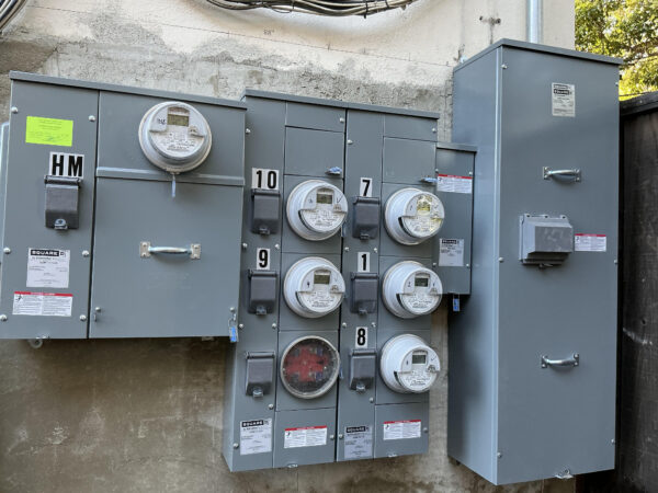 apartment electrical meter stack showing multiple electric meters for multi-unit building power distribution