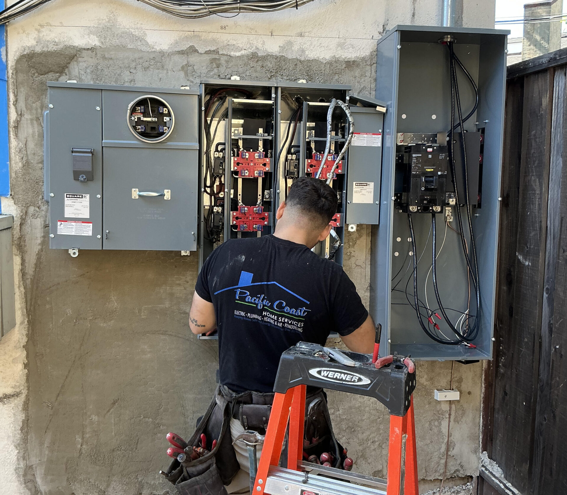 Pacific Coast Home Services Electrician Inspecting Apartment Meter Stack Emergency Air Conditioning Service & Repair